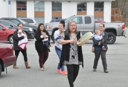 Lena Ross leads a procession of moms into the Longhouse.