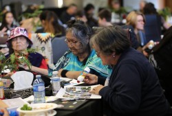 Elders, including Tuu paat (left) and čiisma (centre) and Angie Miller relax and play Nuu-chah-nulth bingo at the event. 