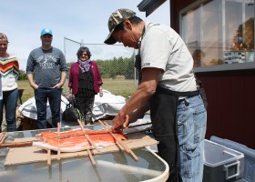 Placing red cedar strips to secure the salmon