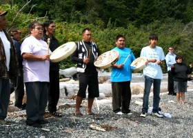 Singers greet the guests on the beach at Yuquot