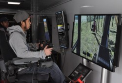 Aaron Jimmy operates a virtual "processor" that can fell, limb and de-bark a tree.