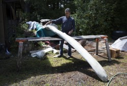 Joe Martin prepares to cut up the lower jaw bone of a grey whale outside his workshop.