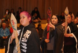 Women perform a traditional paddle dance in the House of Unity on July 16.