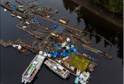 A derelict fish farm lies on the west coast of Vancouver Island. (Coastal Restoration Society photo) 