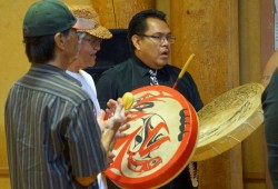 Reuben Thomas, left, Wally Samuel, centre, and Roman Frank   sing and drum a Nuu-chah-nulth song on National Indigenous Peoples Day.