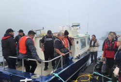 Leaders from the Gwa'sala-'Nakwaxda'xw Nations, including Hereditary Chief Paddy Walkus, speak to Fisheries Minister Joyce Murray on a Mowi Canada West salmon farm in their traditional waters on Friday, Oct. 14. (Coalition of First Nations for Finfish Stewardship photo)