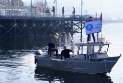 Henderson Charlie (front), dive team leader and his brother Greg Charlie (back) scan the Alberni Inlet for ghost fishing gear and garbage on Feb. 25. Greg Boyd (left) joins the team to download video footage of the dives. (Karly Blats photo)