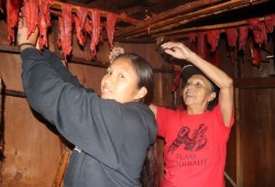 Jean Ignace checks her smoked salmon with granddaughter, Belinda Frank