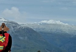 Harry Brossault, a Wit Wak guardian with Huu-ay-aht First Nations, stands atop Heather Creek looking onto Mount Arrowsmith. (Submitted photo)