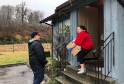 A young man accepts a care package for his Tseshaht grandmother on March 28.