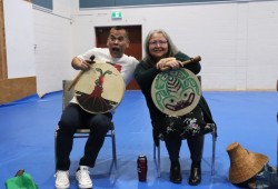 Trevor Little and Lena Ross in a drumming circle at Maht Mahs.