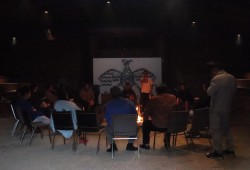 Fathers and other male figures wait for their families in the longhouse with Trevor Little.