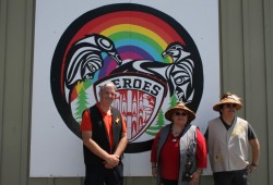 John Howitt Principal Steve Brown stands with artist Geena Haiyupis and her son, Rave Sutherland, who helped to create the mural behind them.