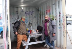 Leon Titian (right) stands with others behind the SIS facility.