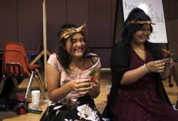 Jaidin Knighton (left) and Daisy John attach cedar roses to their dresses before their Grade 7 graduation ceremony begins at Haahuupayak Elementary School, in Port Alberni.