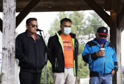 Tla-o-qui-aht First Nation elected chief Moses Martin (left) speaks to a crowd of people gathered in Tofino's Village Green to honour the survivors and victims of the residential school system on the first National Day for Truth and Reconciliation, on September 30, 2021.