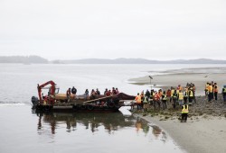 The totem pole is prepared to be carried to a site in Opitsaht for its raising, on Meares Island, on June 29, 2022.