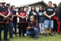 Members of the Martin family gather together in ceremony before the raising of the totem pole, in Opitsaht, on Meares Island, on July 1, 2022.