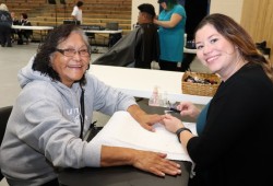 Marie Samuel gets her first manicure from Angelina Zarantonello.