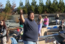 Tseshaht member Robert Watts explains to high school students the protocol of coming to shore.