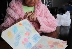 Rowena Cootes looks over contents of a folder discovered among the effects of a former AIRS employee.