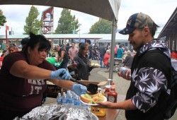 Lisa Watts serves Johnathan Edgar at the annual picnic.