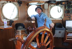 Sean Mather steers Uchuck III through Muchalaht Inlet into Nootka Sound during one of their day cruises to Friendly cove.