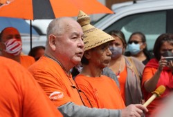 Charlie Thompson, a member of the Ditidaht First Nation and former student of the Alberni Indian Residential School, speaks alongside Ha’wiih at a gathering on the former school site. (Eric Plummer photo)  