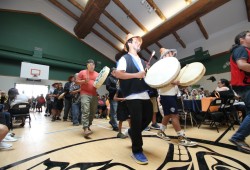 Huu-ay-aht members enter the longhouse on July 26 to begin cultural performances.