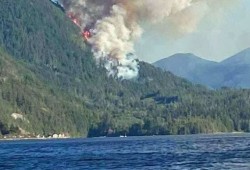 The fire could be seen on the slope above the China Creek Campground and Marina. (Royal LePage Oceanside/Facebook photo)