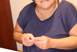 Shawnee Thomas demonstrates beading at the symposium. 