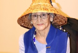 Barb Johnson of Huu-ay-aht models a kakawin (orca) cedar bark hat she made.