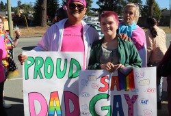 Bee Sayers and their father of Hupačasath arrived early on the morning of Sept. 20, before the rally began holding their posters to catch the eyes of students and parents driving to school to raise awareness of the day’s rally.