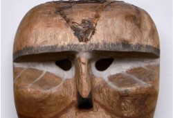 The second mask is made of red cedar wood, bark and is painted with nails and a white feather attached. It is believed to be either a Nuu-chah-nulth or Kwakwaka̓wakw rendering of a sasquatch and was created around ̣1900.