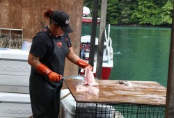 Krissy Edgar cuts up some seafood for hungry hikers at the Nitinaht Crab Shack.