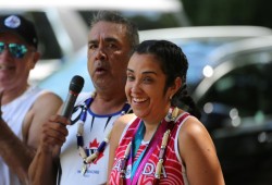 Jolyn Watts smiles as her father Lloyd Watts speaks during the gathering.