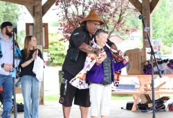 Owner of Tofino’s Common Loaf Bake Shop Maureen Fraser, one of the original Tribal Park Allies, is blanketed by Saya Masso on Aug. 10 at Tofino’s Village Green. 