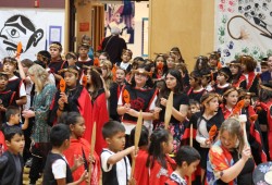 Students raise up paddles during the Oct. 8 celebrations.