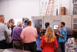 JP Hastey of Kuunaa Foods, speaks to a group about the new high-pressure processing machine at the Dock +.
