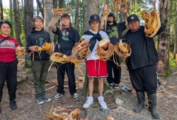 Students display cedar bark strips. 