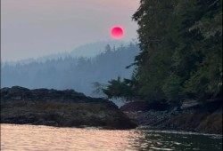 The smoke filled air make the sun apear red over Pachena Bay on Aug. 12. (Danny Bishop photo)
