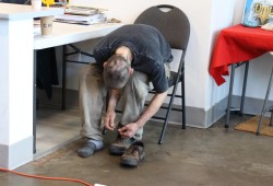 A man receives shoes from Culture Saves Lives.