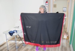 Tla-o-qui-aht elder Grace George shows off young dancer Chenoa’s shawl.