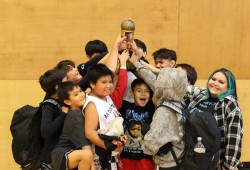 Tla-o-qui-aht U13 boys Wolf Pack hoist the big trophy after beating the Ahousaht Guardians 54-38 on Oct. 25 in Hitac̓u.