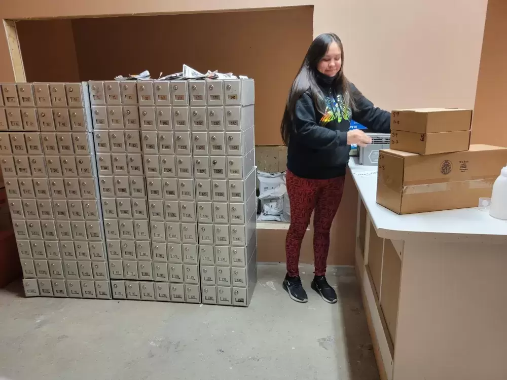 Ahousaht Postmaster Rebecca Martin prepares the post office for Ahousaht residents. (June Titian photo)