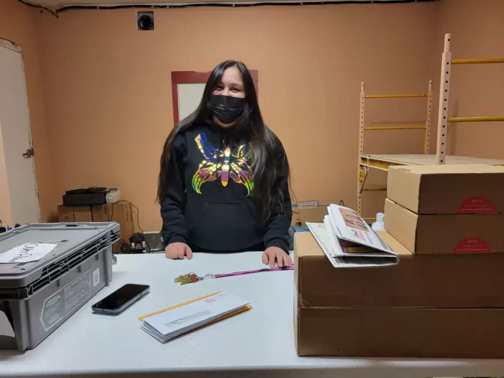 Ahousaht Postmaster Rebecca Martin prepares the post office for Ahousaht residents. (June Titian photo)