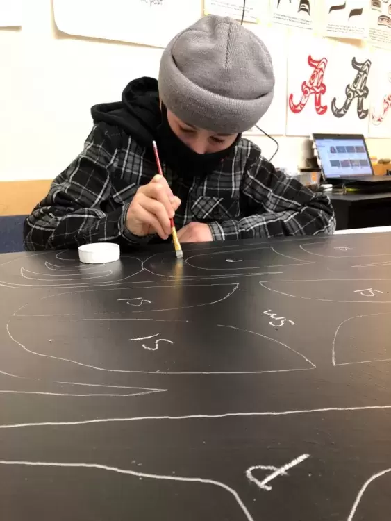 Aidan Nelson works on the 2-D canoe project at ADSS. (Photo supplied by Geena Haiyupis)