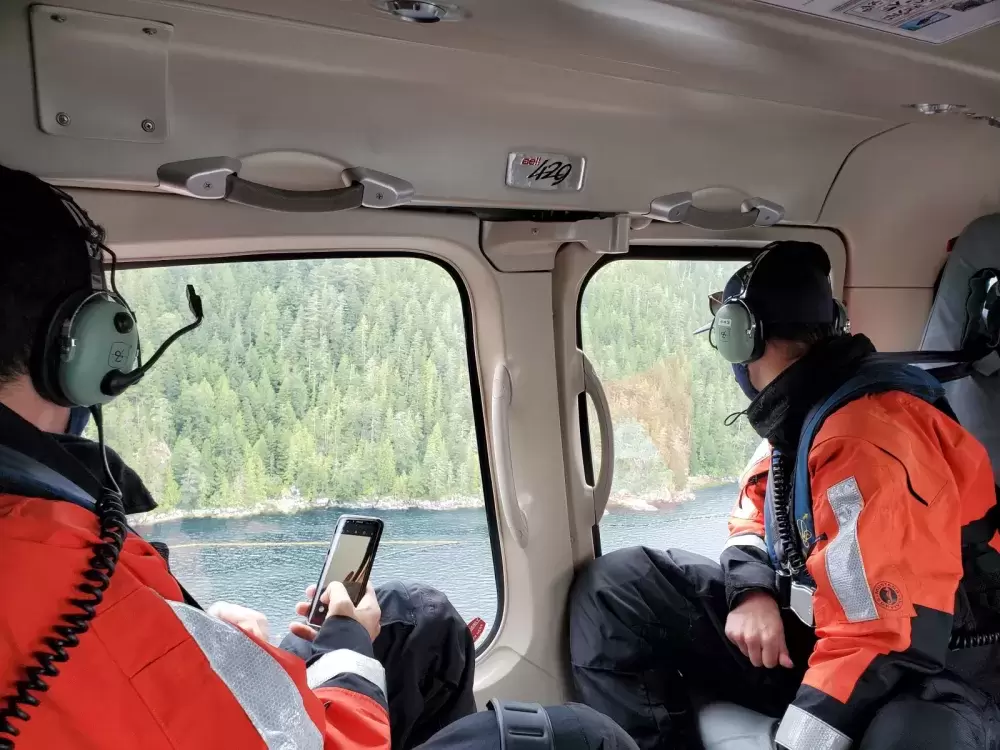 Crew surveys the spill site from a Coast Guard helicopter.