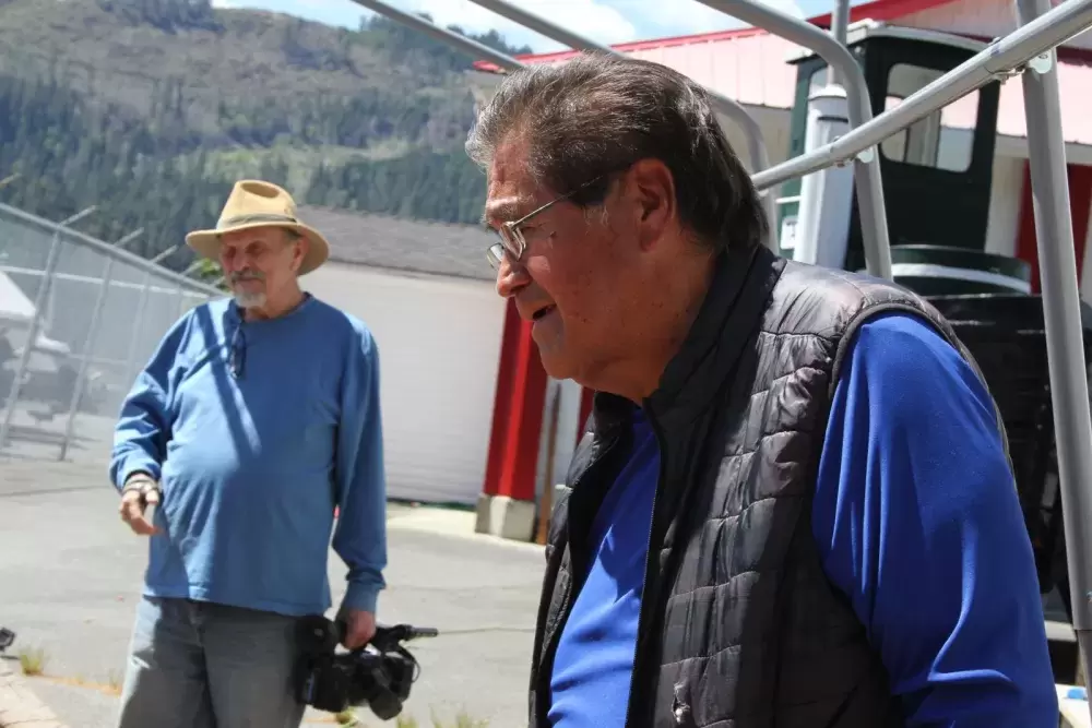 Tim Paul looks over the project as filmmaker Dale Devost holds his camera.