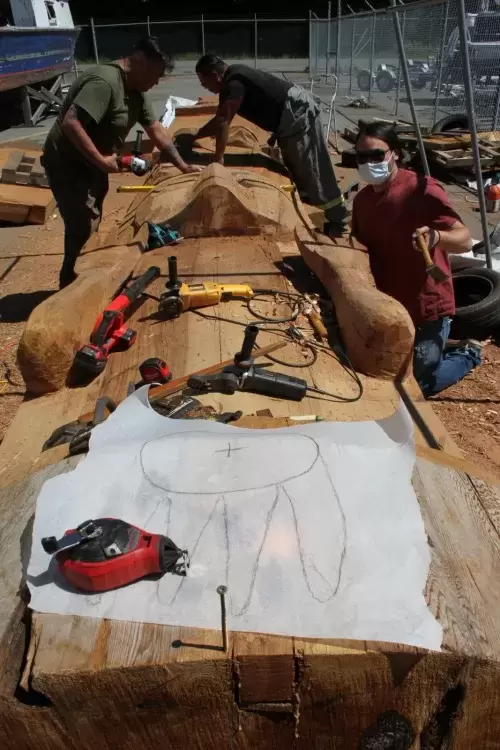 Moy Sutherland Jr., Guy Louie Jr. and Josh Prescott rework a totem pole at Port Alberni's waterfront.